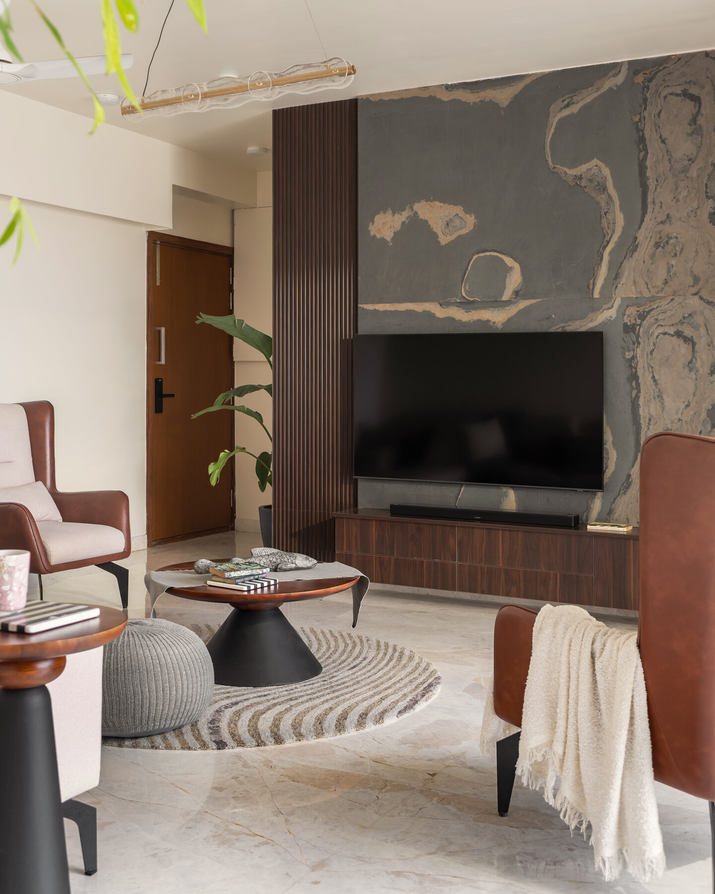 Living lounge with stone feature wall and walnut TV unit